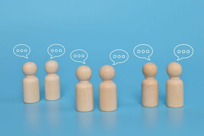 wooden figure with notification icons of message chatting social media interactions