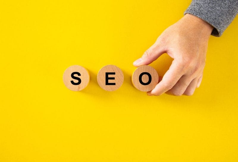 seo search engine optimization text wooden cube blocks on yellow